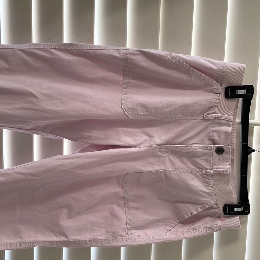 Pink cotton pants with partial elastic band and pockets.